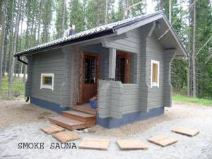 a small house in the middle of a forest at Holiday Home Kärkelä by Interhome in Sulkava