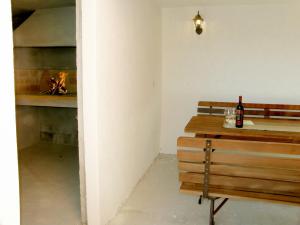 a room with a table with a bottle of wine and a fireplace at Apartment Maslina-3 by Interhome in Srima +10 photos