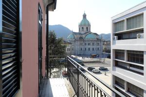a balcony with a view of a building and a street at Gira Guest House in Como
