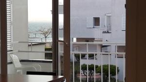 a room with a balcony with a view of the ocean at Residencia Platja de Roses in Roses