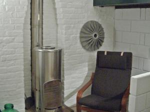 a chair and a radiator in a room with a wall at Apartment Holly Lodge Coach House by Interhome in London