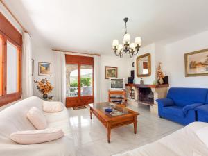 a living room with a couch and a table at Holiday Home Mas Vila by Interhome in Sant Antoni de Calonge