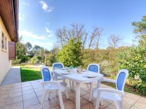 Biały stół i krzesła na patio w obiekcie Holiday Home Les Vignes Océanes by Interhome w mieście Capbreton