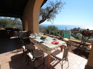 een tafel en stoelen op een patio met uitzicht bij Holiday Home Villa Sara by Interhome in Finale Ligure