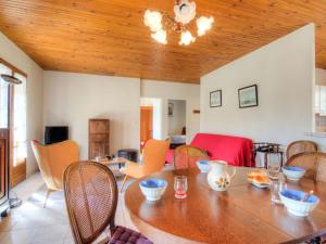 a dining room with a wooden table and chairs at Holiday Home Les Vignes Océanes by Interhome in Capbreton