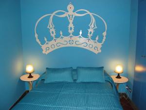 a blue bedroom with a bed with a crown on it at Apartment Campo de' Fiori Bright by Interhome in Rome