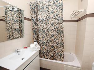 a bathroom with a shower curtain and a sink at Studio Studio Ericeira by Interhome in Ericeira