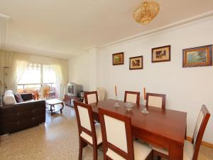 a living room with a wooden table and a dining room at Apartment Rambla de Tossa by Interhome in Tossa de Mar