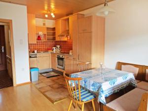 a kitchen and dining room with a table and chairs at Apartment Annemarie by Interhome in Glanz