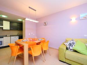 a dining room with a table and a couch at Apartment Can Pavet by Interhome in Vilafortuny