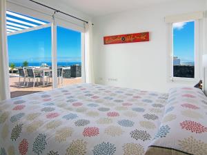 a bedroom with a bed and a view of the ocean at Holiday Home Pelzer by Interhome in Conil