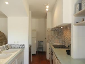 a white kitchen with two sinks and a counter at Holiday Home Domaine du Dragon-4 by Interhome in Lentier