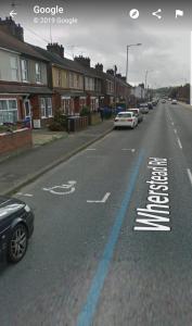 a street with cars parked on the side of the road at Wherstead Road House in Ipswich