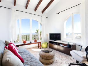 a living room with a couch and a tv at Villa Flores by Interhome in Monte Pego