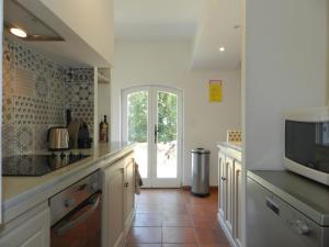 a kitchen with a sink and a microwave at Holiday Home Domaine du Dragon-4 by Interhome in Lentier