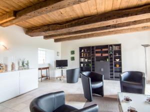 a living room with black chairs and a table at Holiday Home La Hulotais by Interhome in Saint Malo