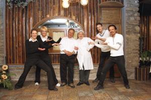 a group of people posing for a picture in a room at Chalet Sul Lago Hotel In Montagna in Moncenisio