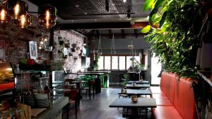 a restaurant with tables and chairs and a brick wall at Tranquil Tree Views 2 Bedroom 2 Bathroom Apartment in Perth