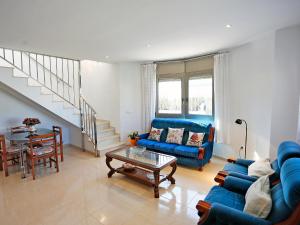 a living room with a blue couch and a table at Holiday Home Solimar Cambrils by Interhome in Cambrils