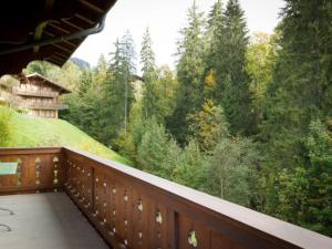 a balcony with a view of the woods at Apartment Graebi by Interhome in Gstaad