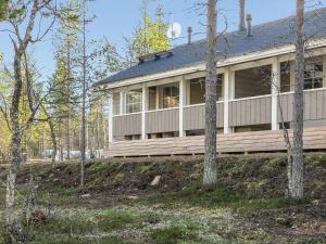 a house on top of a hill with trees at North Frontier 2-bedroom cabin in Saariselka
