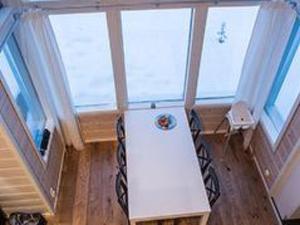 a kitchen with a white refrigerator in a room with windows at Holiday Home Oppas lapland levi by Interhome in Levi