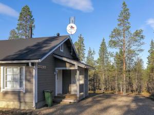 a small house with a clock on the top of it at North Frontier 2-bedroom cabin in Saariselka