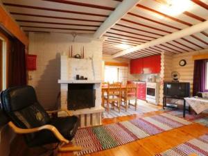 a living room with a fireplace and a dining room at Holiday Home Ravelin by Interhome in Ylläsjärvi