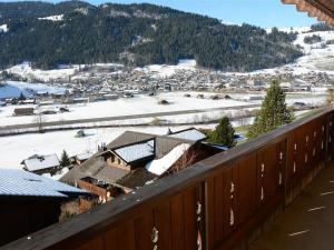 a view from a balcony of a town with snow covered roofs at Apartment Fabiana by Interhome in Zweisimmen