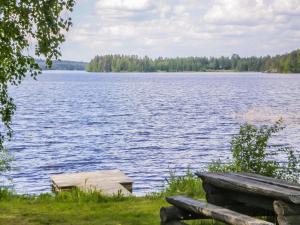 a bench sitting next to a large lake at Holiday Home Ettone by Interhome in Lipinlahti