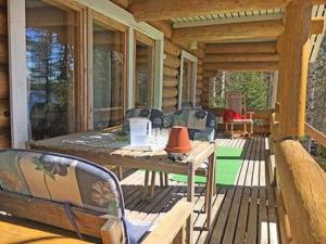 a wooden deck with a table and chairs on a porch at Holiday Home Suviranta by Interhome in Syvärinpää