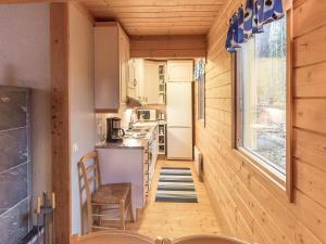 a kitchen in a tiny house with a table and chairs at Holiday Home Mirus by Interhome in Böle