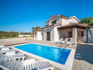 a villa with a swimming pool and chairs at Holiday Home Dorijano by Interhome in Ripenda Kras