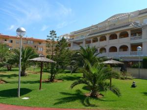 un patio con palmeras y un edificio grande en Apartment Luz del Mediterraneo-4 by Interhome, en Denia