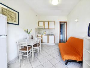 a kitchen and dining room with a table and chairs at Apartment Altaluna-5 by Interhome in Nisporto