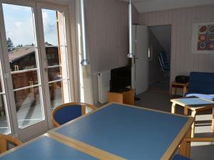 een kamer met een blauwe tafel en stoelen en een raam bij Apartment Arlette Nr- 30 by Interhome in Gstaad