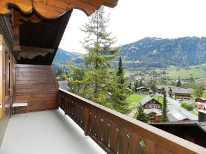 a balcony with a view of a mountain at Apartment Hornflue - Baumann by Interhome in Gstaad