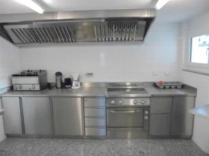 a kitchen with stainless steel appliances in a room at Apartment Weideli by Interhome in Saas-Grund