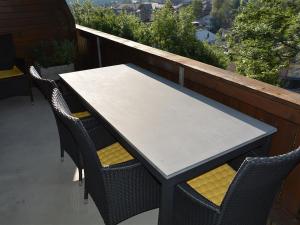 a table and chairs sitting on a balcony at Apartment Hübeli - Arm by Interhome in Zweisimmen