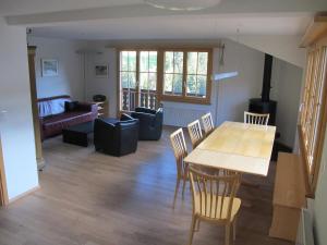 a living room with a wooden table and chairs at Apartment Gilbachhöckli 2 by Interhome in Adelboden