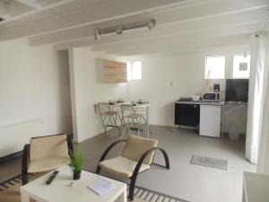 a living room with a table and chairs and a kitchen at Holiday Home Bbrik-1 by Interhome in Hoge Seine