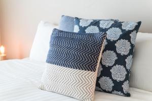 two pillows on a bed next to each other at Sullivans Cove Apartments in Hobart