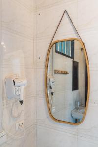 a bathroom with a mirror and a sink at Hi Grey Hostel Xingping in Yangshuo