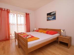 a bedroom with a bed and a window and a bed sidx sidx sidx at Apartment Jasminka-1 by Interhome in Drage +14 photos