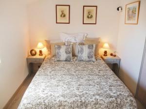 a bedroom with a large bed with two lamps at Holiday Home Domaine des Vignes by Interhome in Cogolin