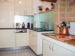 a kitchen with white cabinets and a sink at Apartment Casa Eduardo Apt-2 by Interhome in Ronco sopra Ascona