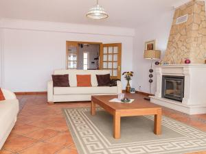 a living room with a couch and a coffee table at Villa Casa da Horta by Interhome in Estevais