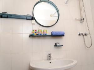 a bathroom with a sink and a mirror at Studio Studio Loureiro by Interhome in Ericeira