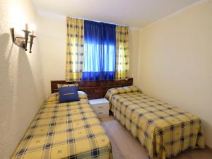 A bed or beds in a room at Apartment DMS IV-3 by Interhome