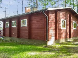 a small wooden building with windows on the side of it at Holiday Home 2233 by Interhome in Savonranta